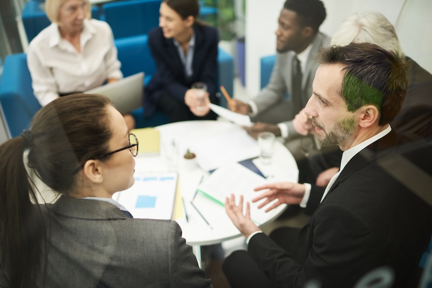 Important Business Meeting in Office High angle view at multi-ethnic group of business people sitting in circle during meeting in office, copy space